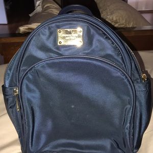 Auth.Michael Kors navy blue/ gold small backbag.